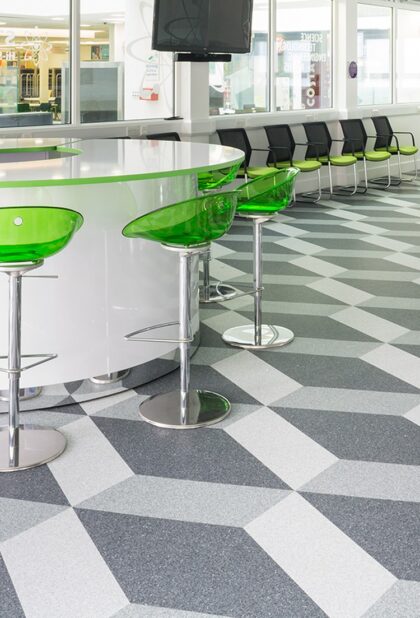 Classic Mystique PUR homogeneous vinyl flooring in a grey geometric pattern beneath a cafe counter