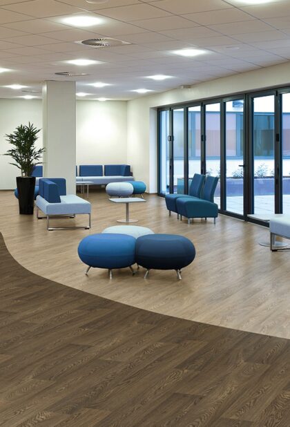 Forest fx PUR heterogeneous vinyl flooring in a pale oak plank design in an office breakout area