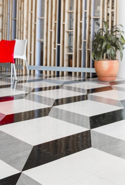 Standard XL PU homogeneous vinyl flooring in a black and white geometric pattern in a foyer